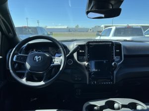 Interior image of a Ram 2500 showing off the steering wheel and infotainment system