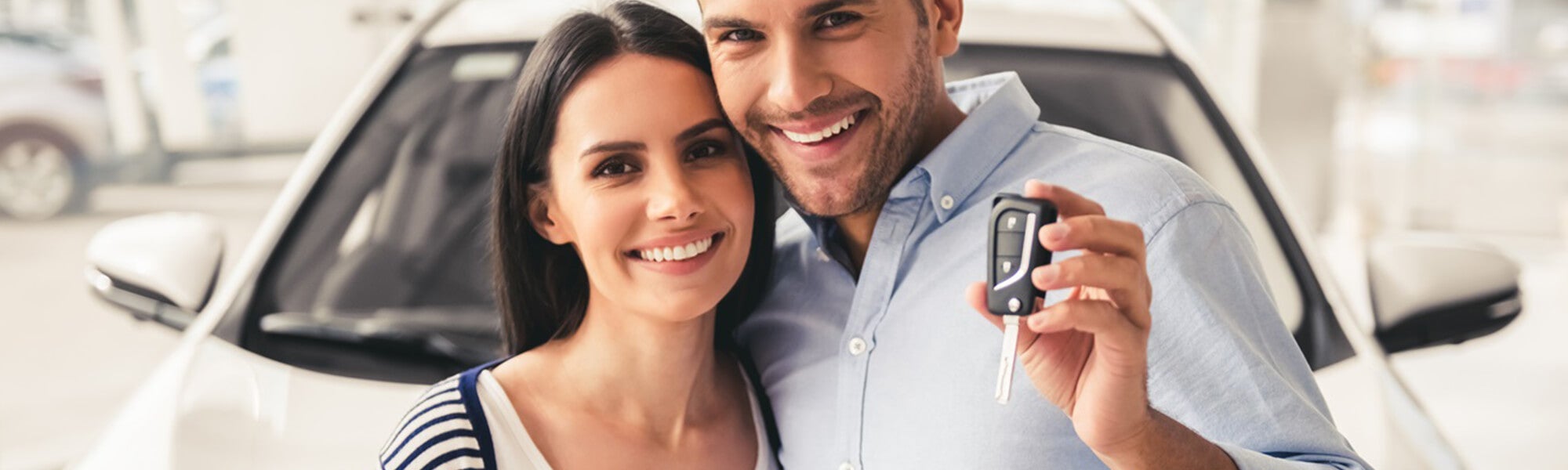 happy couple buying vehicle