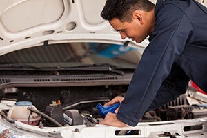 automotive technician doing oil change service